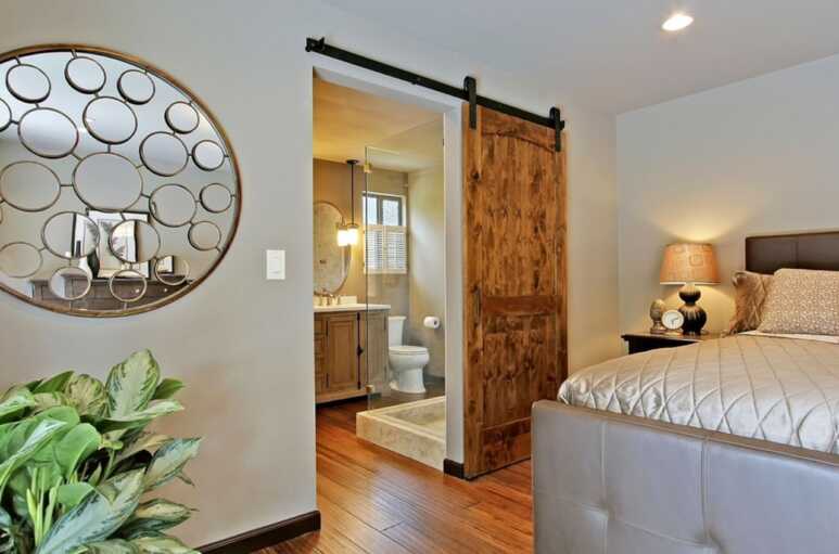 A barn door neatly separates the bathroom and the master bedroom
