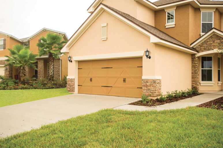 A combination of the swing-out tussock garage door in a peach yellow house