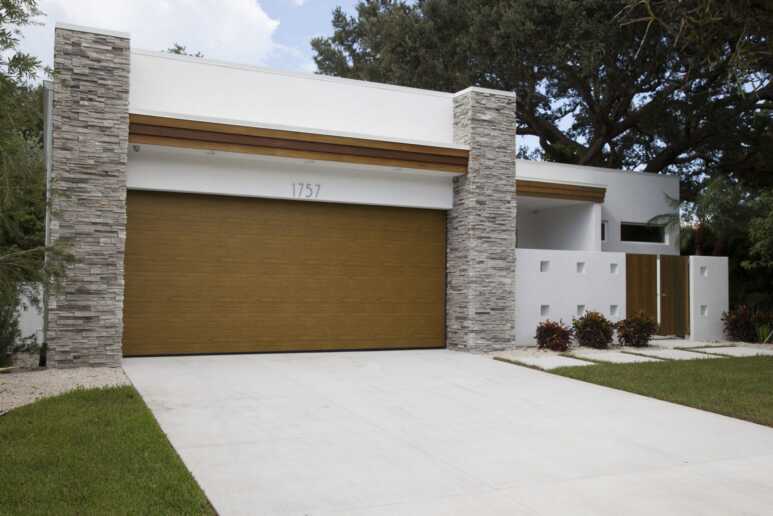 A contemporary house that goes along with a bronze garage door