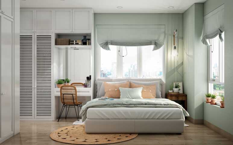 A pretty bedroom wall painted in sage green is paired with the light gray wardrobe