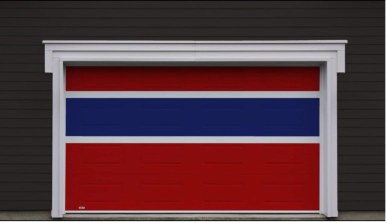 A red and blue garage door with a white frame in black beveled wood siding that is eye-catching