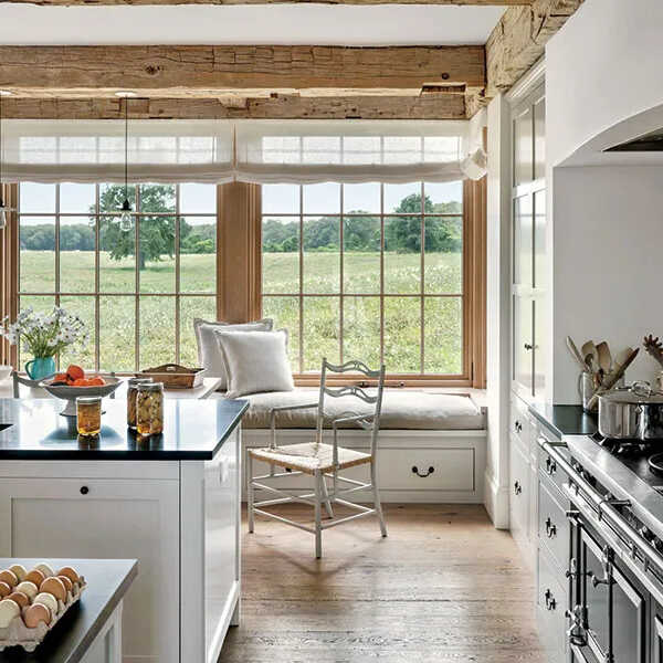 A simple touch of white kitchen island with blacktop in a farmhouse-style kitchen