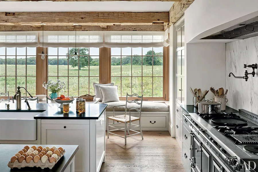 A simple touch of white kitchen island with blacktop in a farmhouse-style kitchen