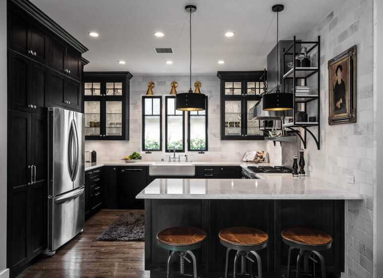 Black kitchen goes along beautifully with the white countertops and white porcelain tile wall