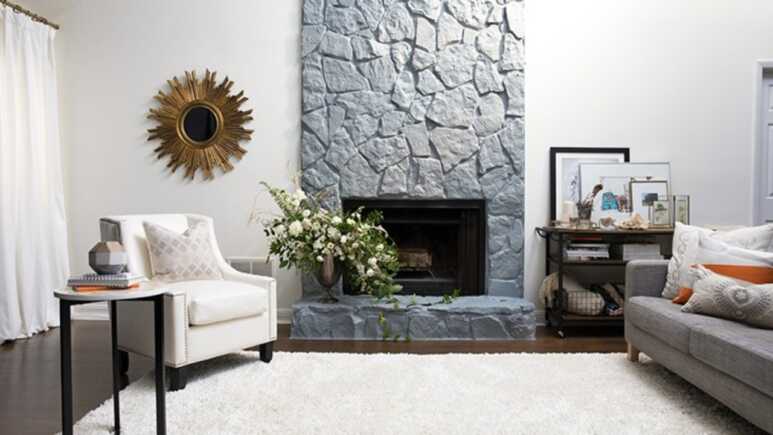 Clean and bright living room combining the light gray stone fireplace and the white-colored wall