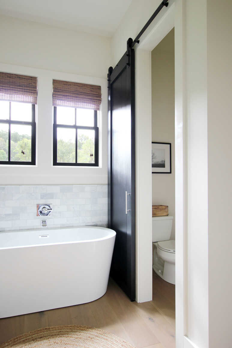 Create a stylish partition in a bathroom using a barn door