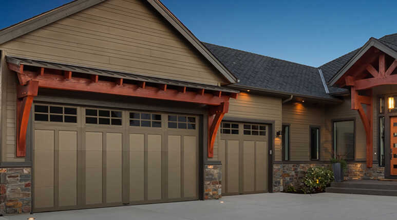 Garage doors covered in two-tone of light brown in a residential house
