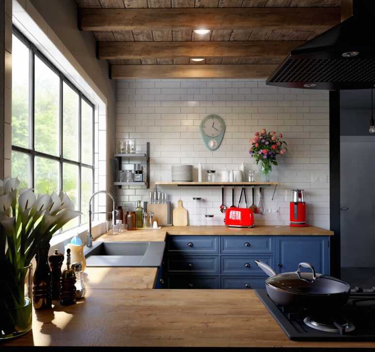 Navy blue kitchen cabinets matched with wooden countertop and colorful details to enhance the charm of a farmhouse kitchen