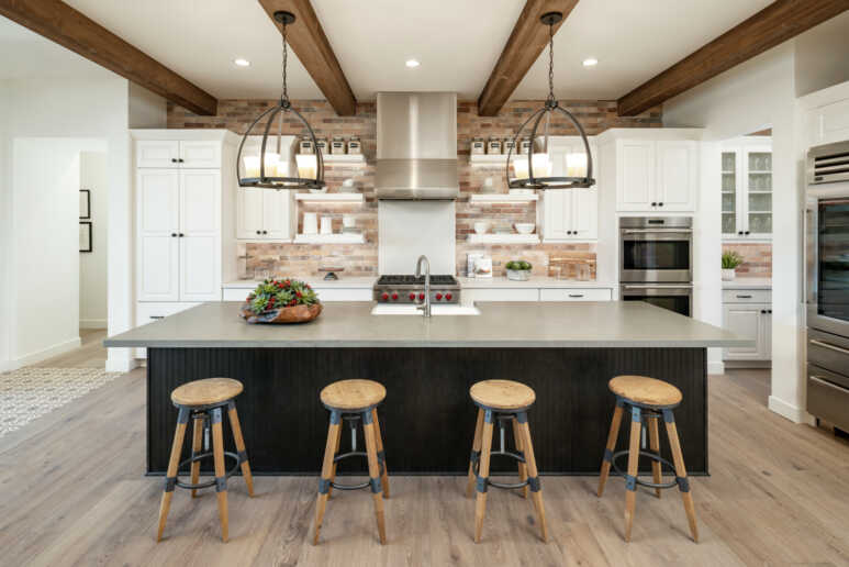 White cabinets and countertops work perfectly together with the black kitchen island